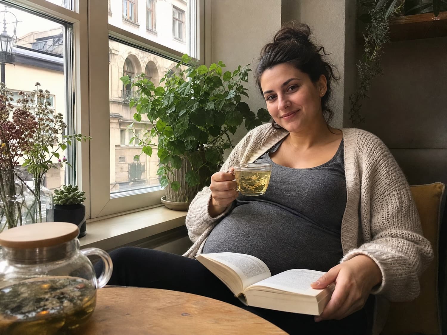 A pregnant surrogate mother with tea by a cozy cafe window