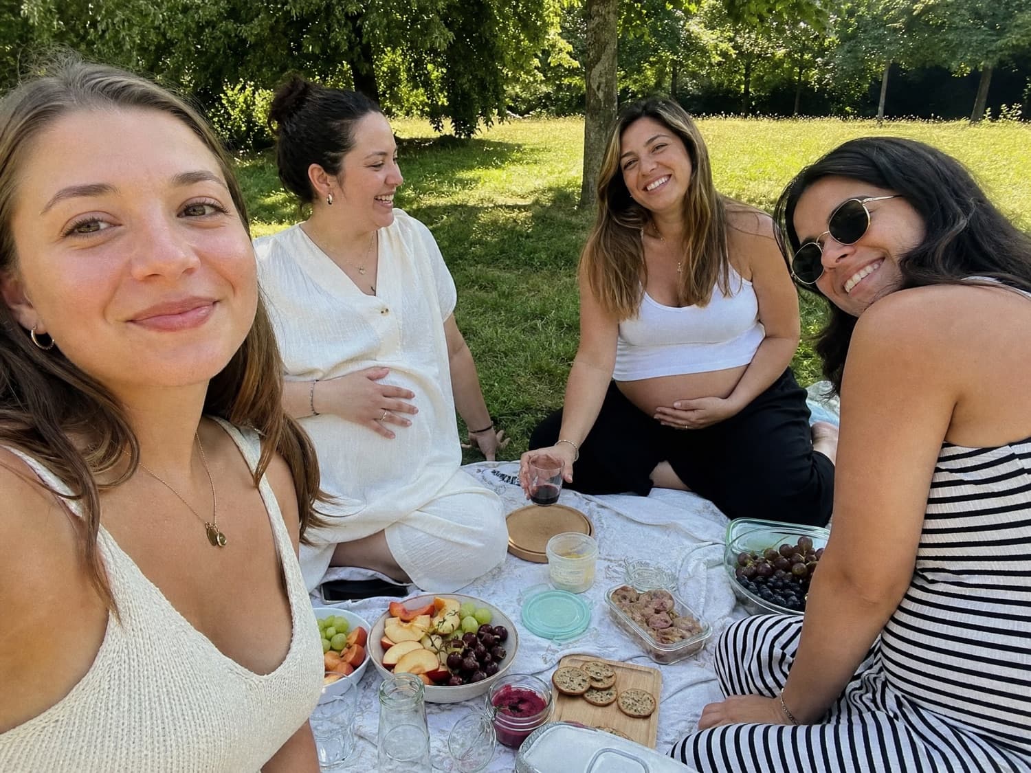 Surrogate mothers enjoying a picnic together in a park